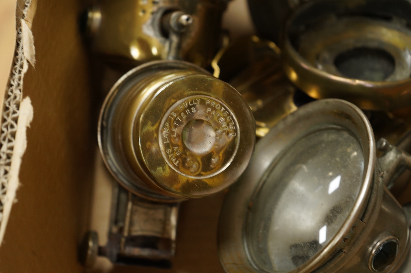An early 20th century Lucas ‘King of the Road’ brass carriage lamp, 35cm high, together with five brass motorcycle lamps by Lucas, etc.